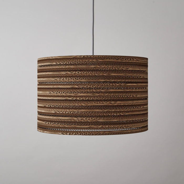 CartOn C1 eco lighting - corrugated cardboard - cylinder pendant, table or floor lamp Eco lighting, handmade in the UK entirely from cardboard. Using cardboard from FSC certified forests and made from 85% recycled material. Maximum wattage: 100w incandescent. Also compatible with CSL and LED lamps of equivalent wattage. The pattern in this cylinder shaped corrugated cardboard lamp shade casts an intricate pattern with a warm glow when lit. Non toxic, biodegradable glue and local materials. See all cardboard light shades at chalkandmoss.com/brand/tabithabargh