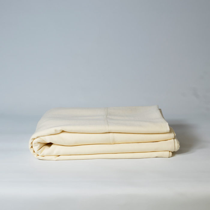 Linen flat sheet in oyster white, olive grey or champagne pink (seen here in oyster white) The unique blend of organic linen and bamboo makes this linen flat sheet soft and easy to care for, without compromise. Affordable, wonderfully soft and natural, these organic bed linens are twice as durable as cotton and can last for decades with the right care. Bamboo minimises creasing in linen and makes the fabric really easy to look after. The Flax Sack’s bedding is a responsible choice, where the fabric improves with age and becomes softer with each wash. Quite simply, a sustainable choice in bedding. Sleeping in linen bedding has a unique weighted and textured quality, that's quite different to other bedding. Naturally antibacterial, hypoallergenic and moisture absorbent, these organic linen flat sheets are also kind to the skin due to the fabric’s neutral pH level and its ability to help regulate body temperature. Linen and bamboo suit sensitive and eczema prone skin, ensuring everyone a good night’s sleep. Why not surround your body with linen bedding, with the flat sheet, duvet cover and pillowcases in the Flax Sack bedding set. Available in three colours. Soft Crease resistant Twice as durable as cotton Sustainable Hypoallergenic Antibacterial Moisture absorbent Becomes softer with each wash Material: 85% flax linen / 15% bamboo Dimensions: Double: 230cm x 270cm King: 275cm x 275cm Choose from natural Oyster White, Olive Grey or Champagne Pink duvet covers, pillowcases or flat sheets to match or complement your decor. The Olive Grey borders on a deep green colour for a luxurious feel. All Flax Sack bedding is available in these colours and a choice of adult and children's bedding sizes (children's bedding comes in only white).