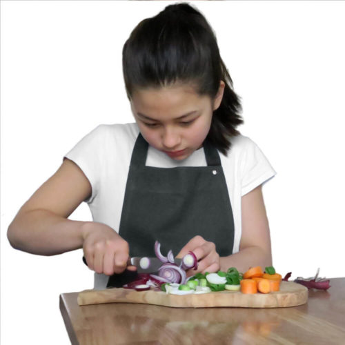 Children's apron, Junior age 7-11 in durable organic cotton. Inviting young chefs to cook, bake and be creative with their families. A simple and practical children's apron design with a neck and waist strap. There is no print on this apron, the design is timeless. Available in dark grey, dark green, dark blue, black, pale rose and sky blue. Seen here in dark grey. 60 x 80 cm For younger chefs, we have the Kids Apron, for 3-6 year olds, also from The Organic Company.