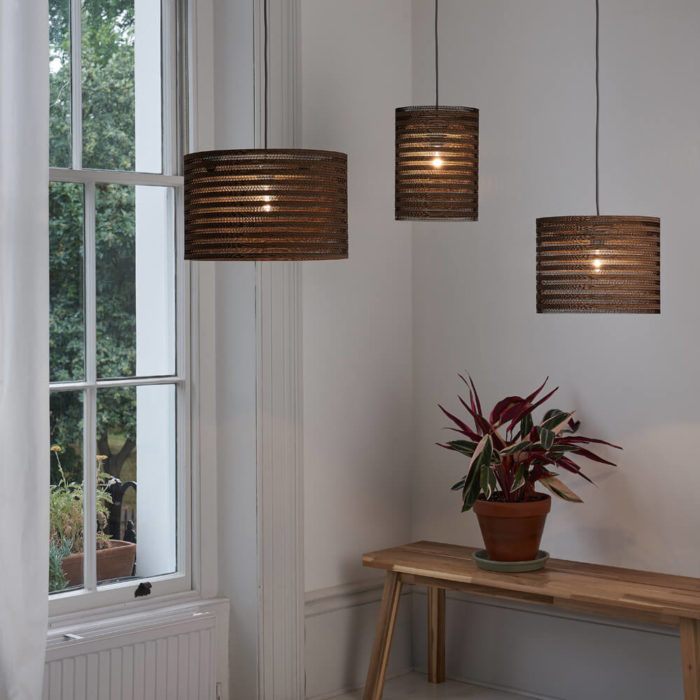 Tabitha Bargh's cardboard light shades. Eco friendly lighting handmade in the UK from FSC certified forests and recycled materials. The material and distinct lines give an atmospheric glow. Available in different shapes and sizes at Chalk & Moss (www.chalkandmoss.com).