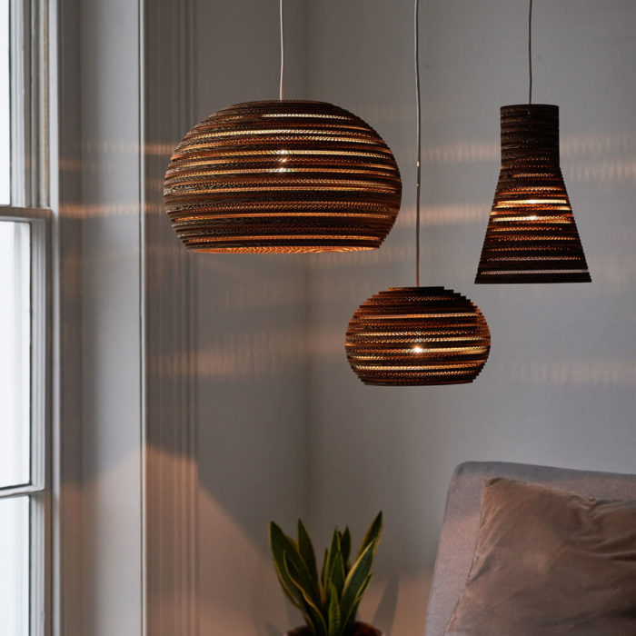 Tabitha Bargh's cardboard light shades. Eco friendly lighting handmade in the UK from FSC certified forests and recycled materials. The material and distinct lines give an atmospheric glow. Available in different shapes and sizes at Chalk & Moss (www.chalkandmoss.com).