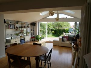 Biophilic Design in practise. Create a seamless bond by blending the greenery outside with plants inside, along with natural materials such as wood and stone. Large windows and reflective surfaces help distribute natural light throughout. 