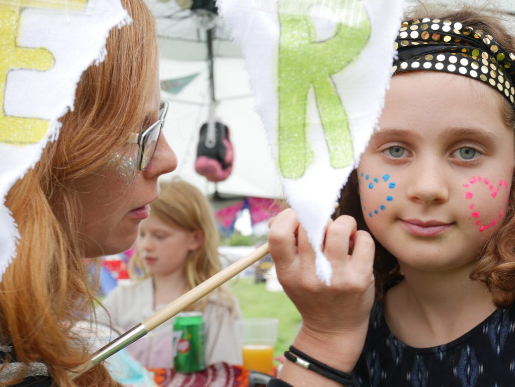 Glittery face paint, neon face decorations and more offered at DIYestival's glitter bar!