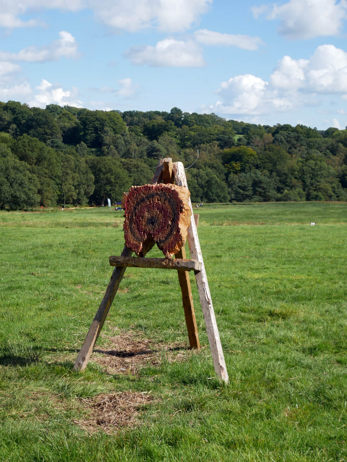 Axe throwing and cross bow practise at Into The Trees family festival at Pippingford Park in Ashdown Forest, Sussex.