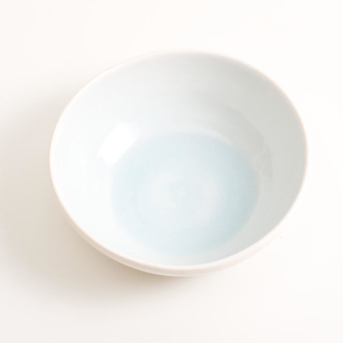 Handmade shallow porcelain bowl in blue. Hand-thrown with natural ridges and pale pastel colour inside. Perfect for cereal or soup. Beautiful on its own or as part of a mix and match set. Available in 4 colours: Pink, blue, turquoise and grey.