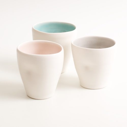 Handmade dimpled mug set. With a matt white glaze on the outside and soft coloured inside. Available in pale blue, pale pink, grey and turquoise. Perfectly formed dimples to fit in your hand, where the shape is inspired by Japanese tea traditions. Handmade by Linda Bloomfield in London. Sold on chalkandmoss.com.