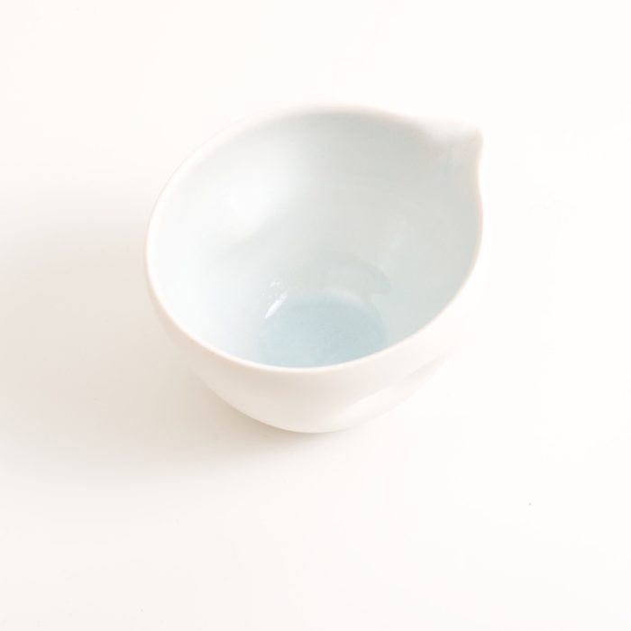 Handmade porcelain pouring bowl small baby blue inside. Small or medium size with tactile dimples instead of handles. Inside glazed in pale blue, turquoise, pink or grey.