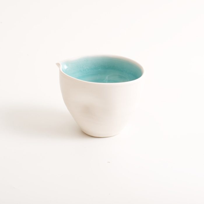 Handmade porcelain pouring bowl small turquoise. Choice of mall or medium size with tactile dimples instead of handles. Inside glazed in pale blue, turquoise, pink or grey.