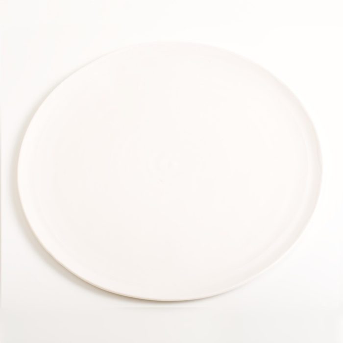 Handmade porcelain plate white. Made in 3 sizes 5 colours. Hand thrown in England, dishwasher safe. These look great as part of a mix and match set. For every day dining and entertaining.