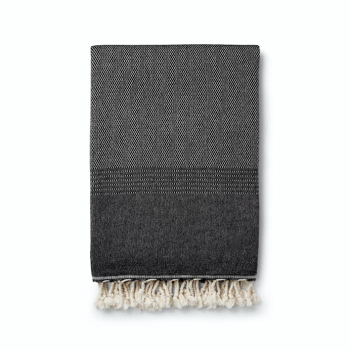 Ekin peshtemal hammam towel in black. Other colours available at chalkandmoss.com. Perfect for the beach, on journeys or as a bathroom towel.