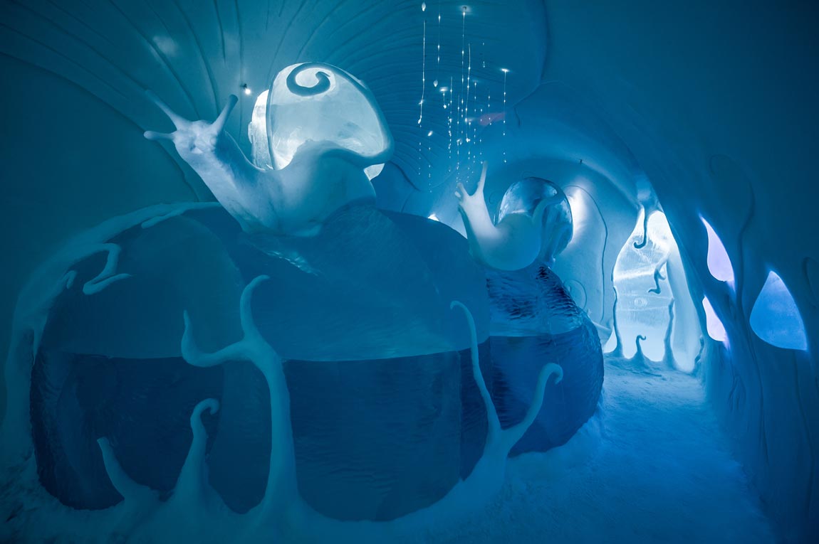 snail sculpture underwater scene at ice hotel