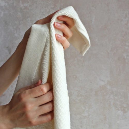 Everyday organic hand towel in a choice of colours: dark grey, natural white, dark blue, sky, clay, pale rose (shown here in white)