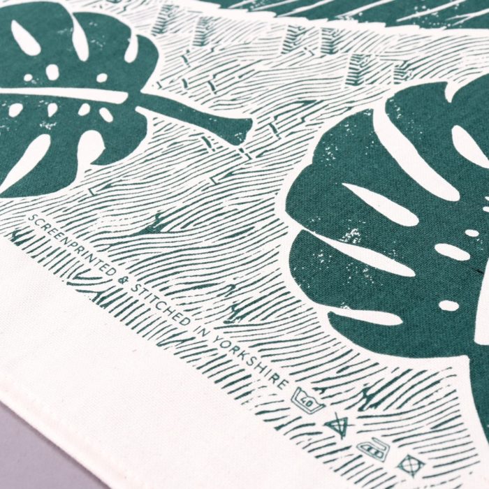 Green tea towel with a large leaf design, shown in closeup. Designed by Wald, sold on Chalk & Moss (chalkandmoss.com).
