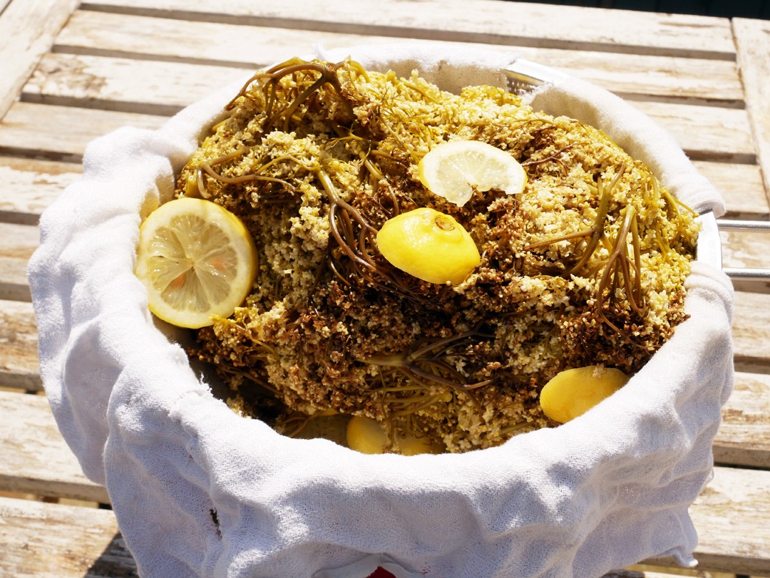 When 2-4 days have passed, strain the elderflower mix through a muslin into a large bowl. I couldn't find my muslin so used an old tea cloth instead!