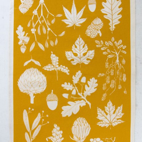 mustard tea towel in winter leaf botanical print. Screen printed in Sussex, UK.