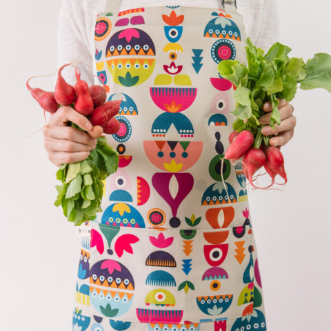 Cooking apron combining Scandinavian shapes and colours with Eastern European folklore. Inspired by retro Christmas tree baubles. Available in two colours. This is the "Bright" design. 60cm X 80cm.