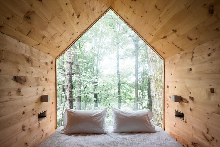 Gather Green rental cabins in NY State. Watch the outside world from the cosy comfort of this fully nature immersed bed. 
