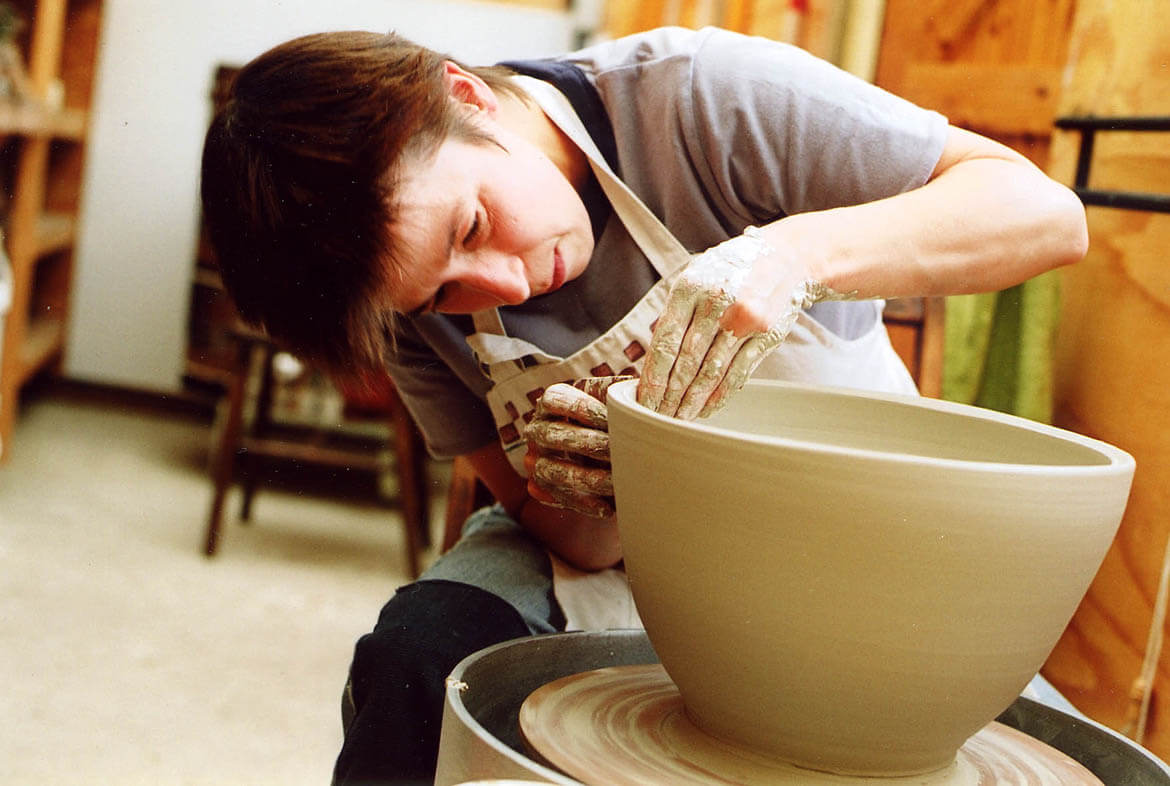 Linda Bloomfield at her pottery wheel in her West London studio.