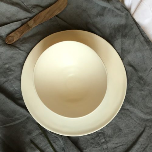 A silky smooth matt white shallow bowl, hand thrown by Linda Bloomfield in London, United Kingdom.